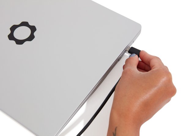 The text, logo, and QR code on the Expansion Card must be facing down (facing the laptop). Slide the Expansion card into the bay. Using two or more fingers push the card until into the bay until it clicks.