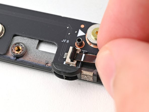 Use your fingers to grip the brown pull tab and slide the fan cable straight out of its socket.