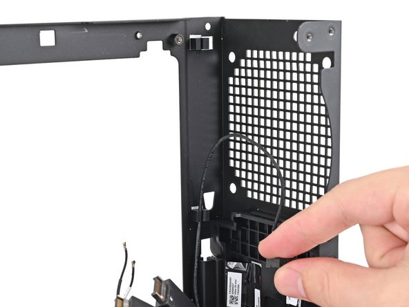 Pull the power button cable out of its rubber clips on the chassis.