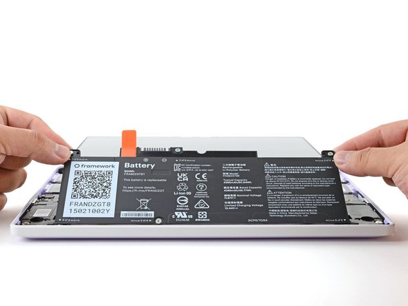 Lay the battery in its recess in the laptop.