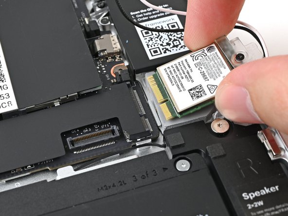 Hold the Wi-Fi module by its edges. Don't touch the gold contacts with your fingers. If you do, wipe the contacts with a clean, lint-free cloth to remove any finger oils.