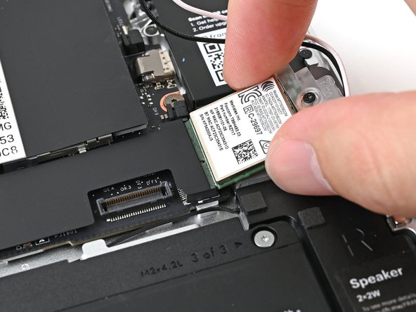 Align the Wi-Fi module's gold contacts and notch with the socket on the Mainboard.