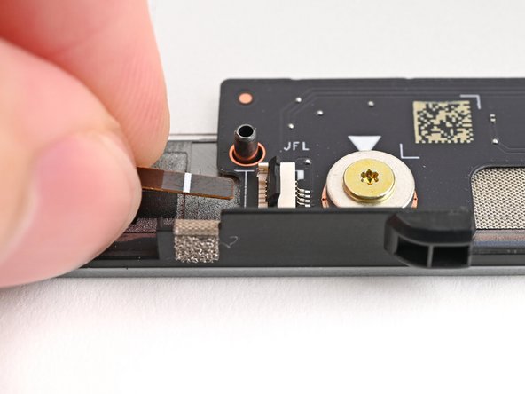 Use your fingers to grip the brown pull tab and slide the left fan cable straight into its socket.