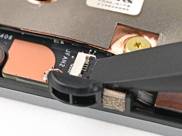 Use the flat end of your Framework Screwdriver, or a clean fingernail, to press down the locking tab on the fan ZIF connector.