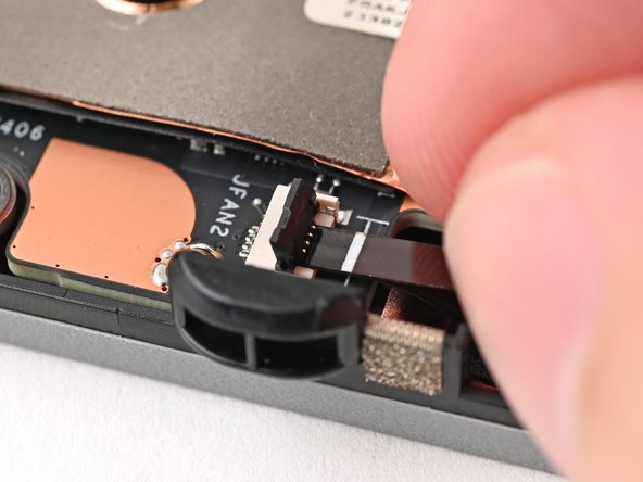 Use the flat end of your Framework Screwdriver, or a clean fingernail, to press down the locking tab on the fan ZIF connector.