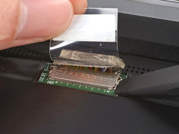 Use the flat end of your Framework Screwdriver to lift up the metal locking tab over the eDP cable connector.