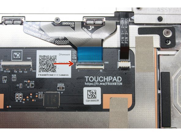 Using the spudger end of the Framework Screwdriver or your fingernail, disconnect the Keyboard Membrane from the Touchpad Module by switching the black latch up and sliding the cable straight out.