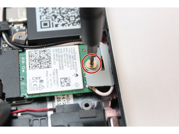 Using the T5 bit in the Framework Screwdriver, unscrew the fastener on the WiFi module.