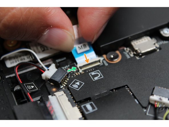 Using your finger or the spudger end of the Framework Screwdriver, flip the black latch down towards the Mainboard to lock the cable in place.