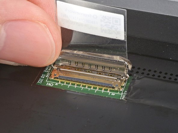 Grip the eDP cable where it meets the connector head.