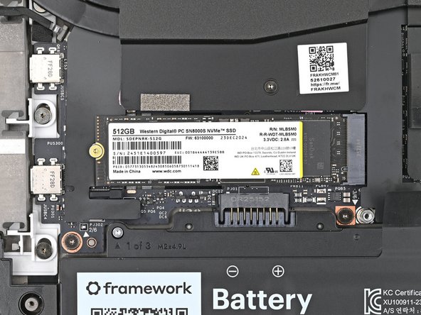 The SSD might pop up at a shallow angle when you remove the screw.