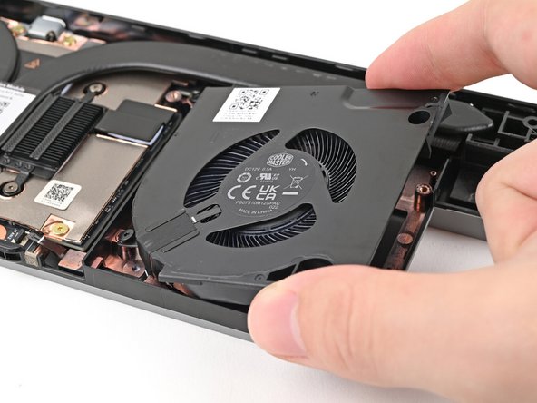 Place the fan onto the Expansion Bay Shell, making sure to thread the cable through its slot.