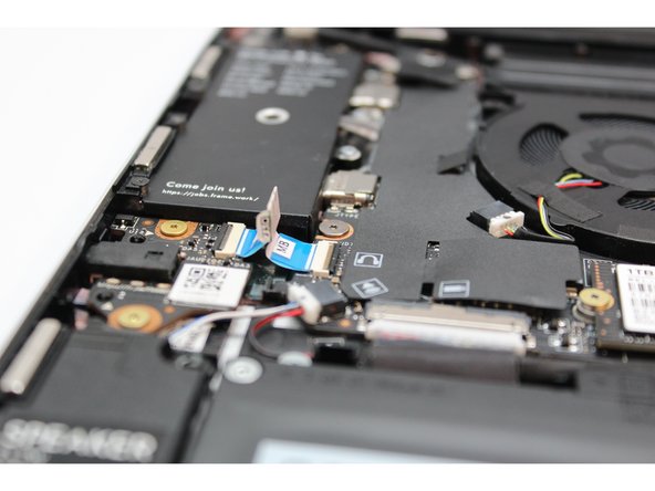 Flip the black latch down to secure the cable in place.