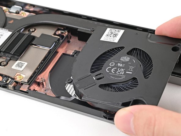 Place the fan onto the Expansion Bay Shell, making sure to thread the cable through its slot.