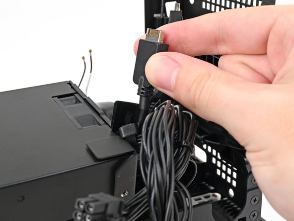 Thread the right Expansion card cable through the gap between the power supply and its duct.
