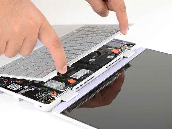 Lift upwards to swing the Input Cover up from the base of the laptop.