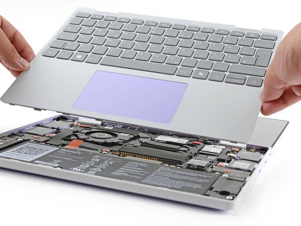 You may feel resistance from the magnets. If the cover feels like it's snagged, check that you've fully loosened the screws on the bottom of your laptop.