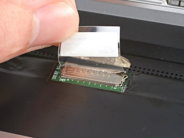 Use your fingers to flip up the plastic tab and access the connector underneath.