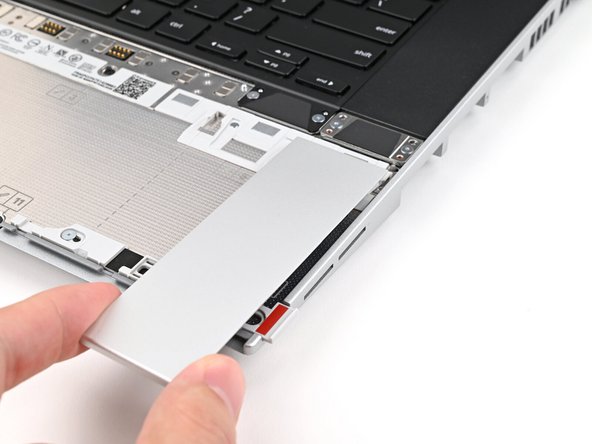 Place the Touchpad Spacer over its spot on the laptop with the bottom edge overhanging slightly.