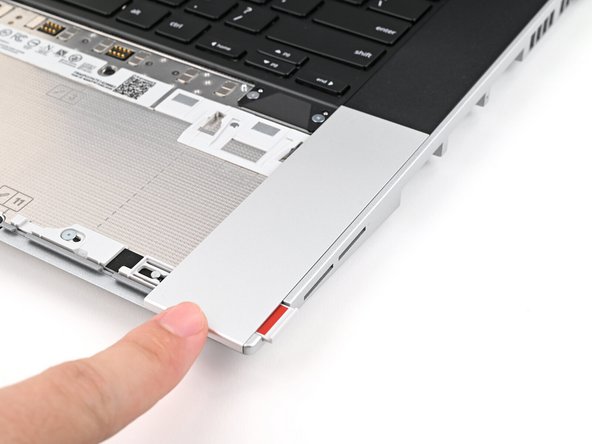 Slide the Touchpad Spacer towards the top of the laptop to secure it.