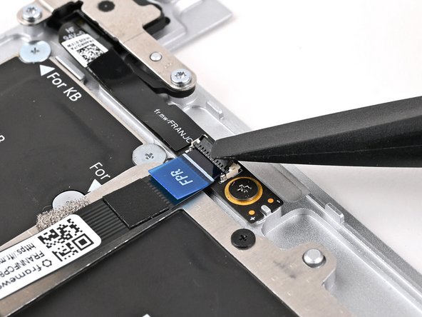 Use the flat end of your Framework Screwdriver, or a clean fingernail, to press down the locking tab on the Fingerprint Reader ZIF connector.