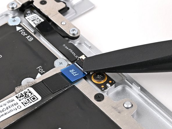 Use the flat end of your Framework Screwdriver, or a clean fingernail, to press down the locking tab on the Fingerprint Reader ZIF connector.
