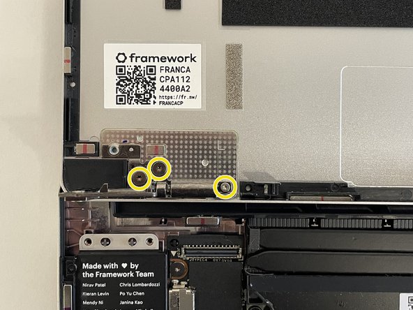 Unscrew the three fasteners on the right Hinge using the T5 bit in your Framework Screwdriver, and then remove the Hinge from the Top Cover.