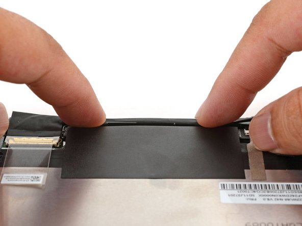 Use your fingers to press the display cable onto the metal back of the display.