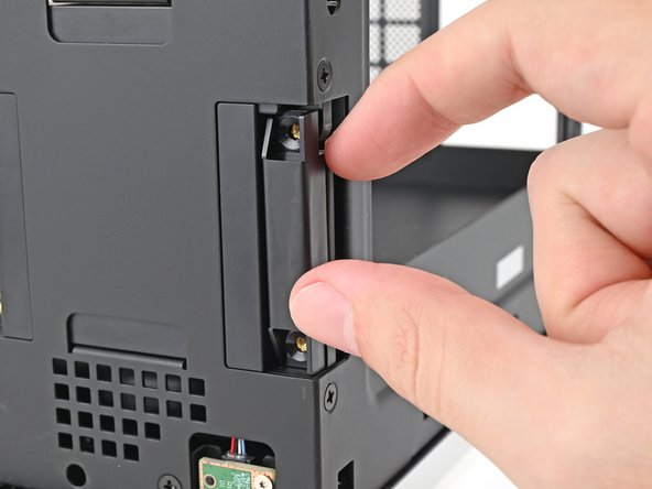 Place the replacement right antenna into its slot on the chassis, making sure to thread the cable through the slot.