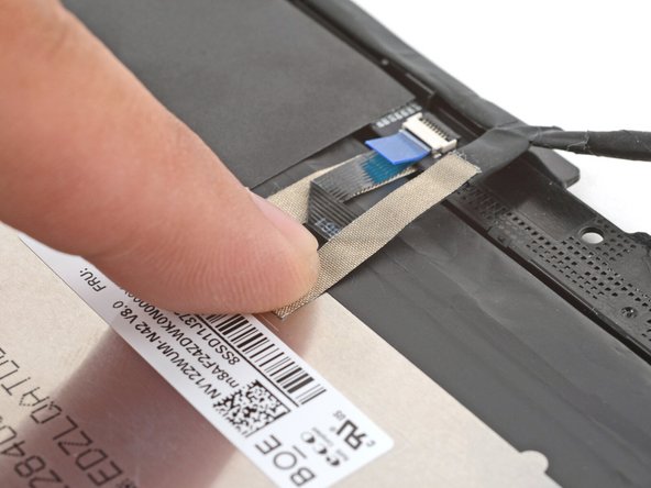 Use your finger to press the display cable grounding tape onto the display.