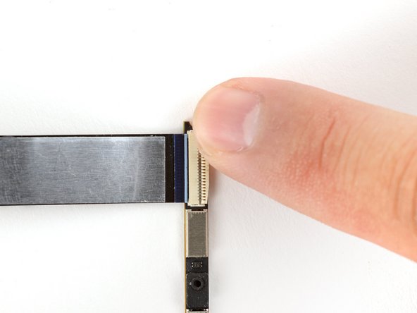 Slide the cable into the webcam module's ZIF connector, up to the printed line on the cable.