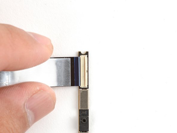 Hold the webcam cable with the shiny side facing up.