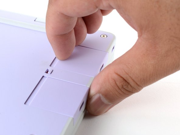 Grip the lip of the Expansion Card with your fingers.