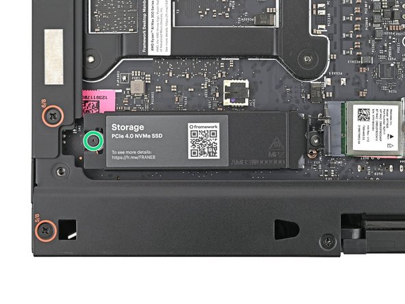 Use your Framework Desktop Screwdriver to loosen the captive T5 Torx screw securing the secondary storage.
