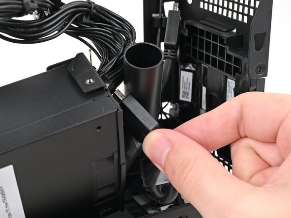 Thread the right Expansion card cable through the gap between the power supply and its duct.