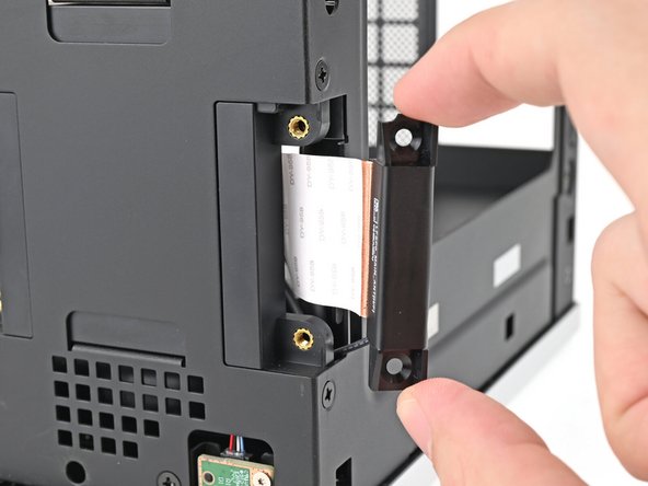 Place the replacement right antenna into its slot on the chassis, making sure to thread the cable through the slot.