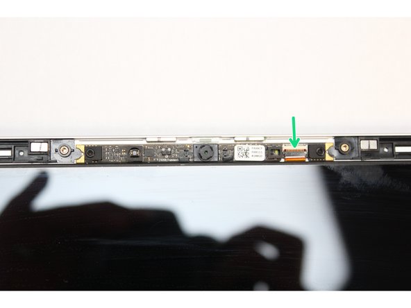 Make sure the black latch on the connector is flipped up so that you can slide the Webcam Cable into the connector. Slide the cable straight in until the white line is almost at the edge of the connector.