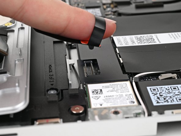 Insert your finger into the Touchpad Cable press connector loop.