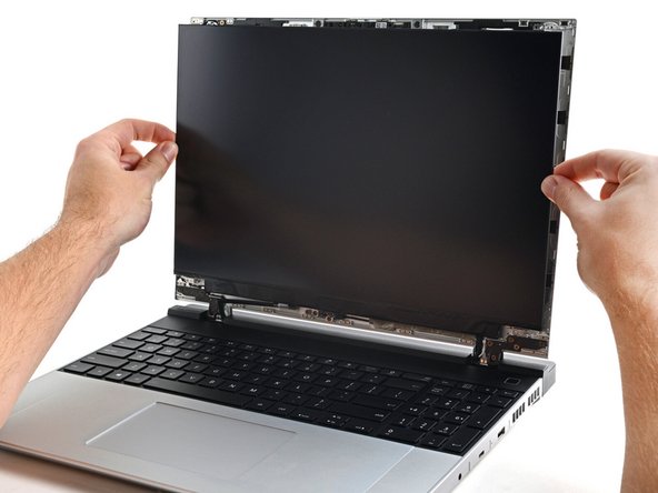 Grab the display and pull it straight off the Top Cover to free it from its alignment pegs.