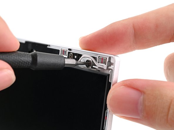 While supporting the display with one hand, use your Framework Screwdriver to remove the four 2.4 mm‑long T5 Torx screws securing the display.