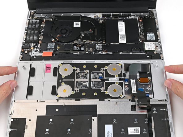 Position the Input Cover, keyboard down, on top of the laptop so it just covers the Battery.