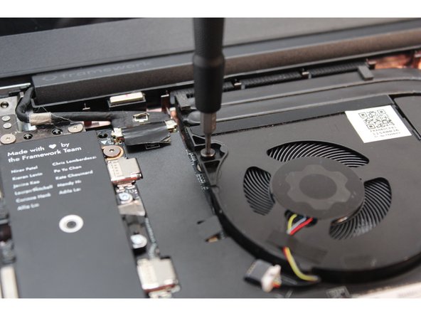 Using the Framework T5 bit in the Framework Screwdriver, unscrew the two fasteners on the Fan first.
