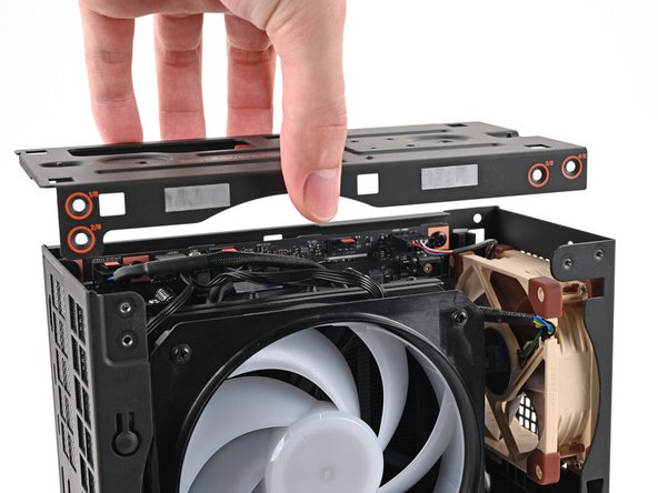 Place the top plate on top of the Desktop, making sure it slots into the chassis so the orange circles are visible.