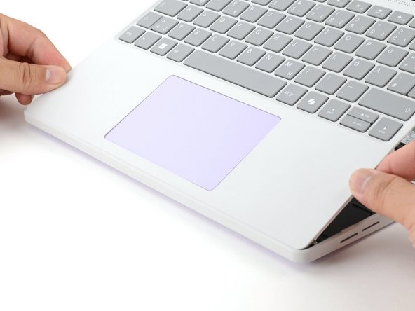 Align and insert the bottom edge of the Input Cover into the base of the laptop.