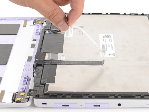 The webcam cable is lightly adhered to the display.