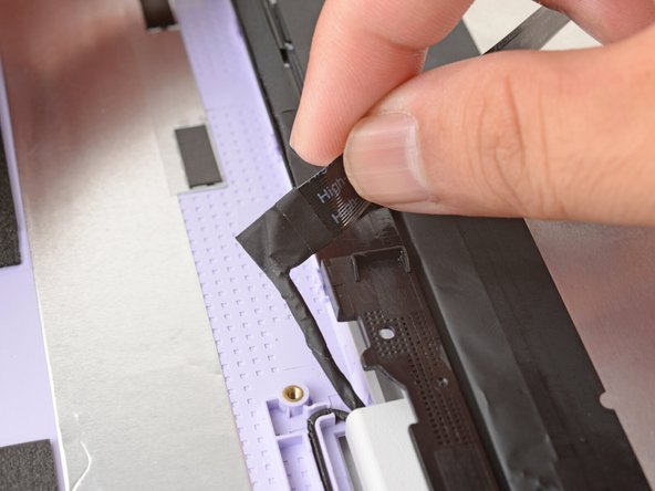 Carefully move the cable off of the display.