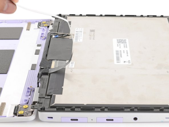 Grab the webcam cable with your fingers and slowly peel it away from the display.