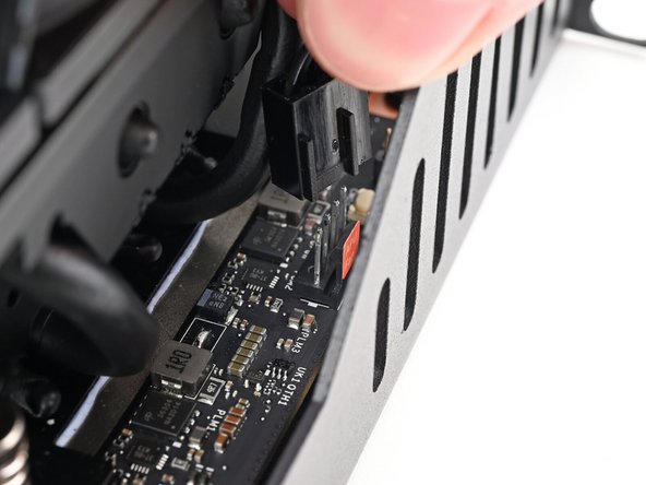 Orient the main fan cable so its two vertical lines are facing the edge of the Tray.