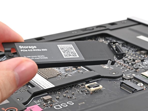 Lift the secondary storage heat spreader out of the Desktop and remove it.