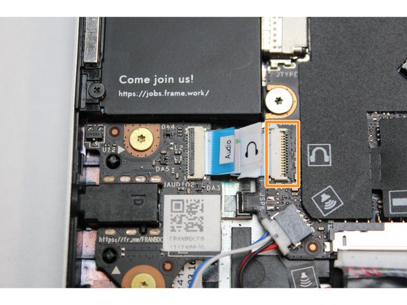 Using your fingernail or the spudger end of the Framework Screwdriver, flip up the black latch on the connector.